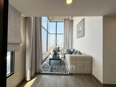 Luxurious high-rise living room with floor-to-ceiling windows and stunning city views.