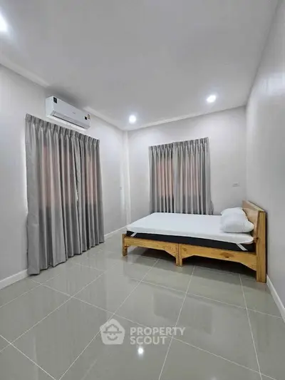 Spacious bedroom with modern air conditioning and elegant curtains