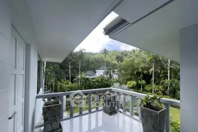 Stunning balcony with lush garden view in tropical setting, perfect for relaxation and enjoying nature.