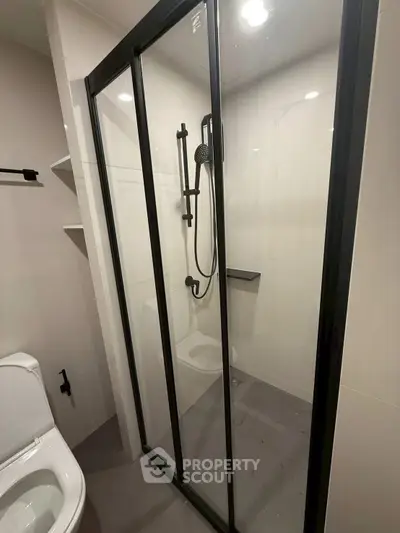 Modern bathroom with sleek shower enclosure and contemporary fixtures.