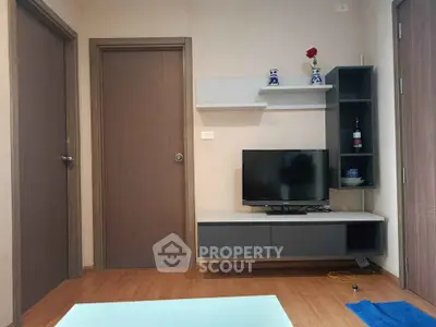 Modern living room with TV and stylish shelving, perfect for cozy relaxation.