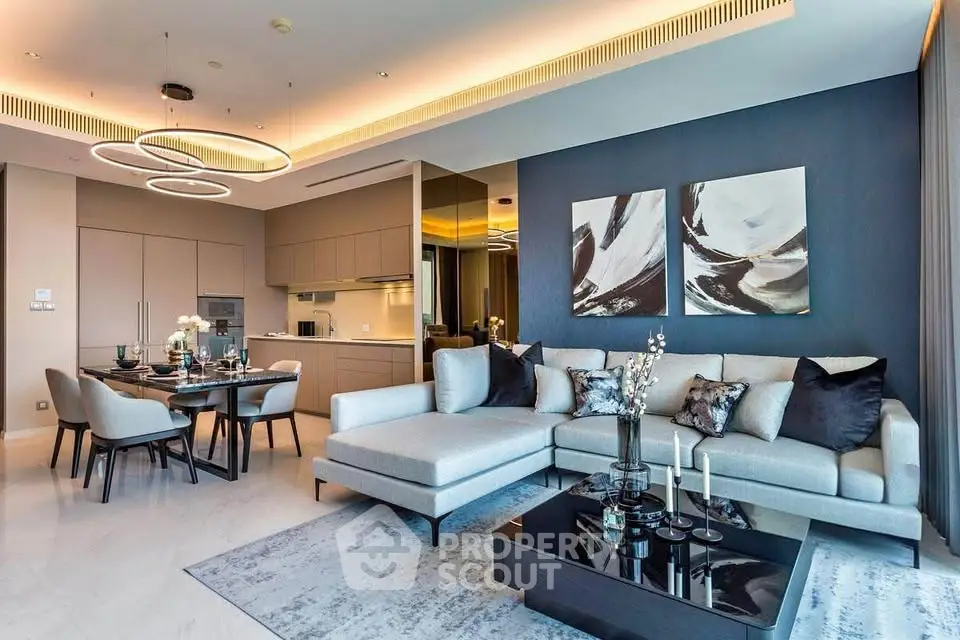Luxurious modern living room with elegant decor and open kitchen layout, featuring stylish furniture and contemporary lighting.