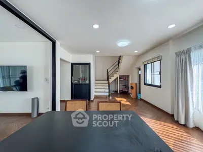 Spacious modern living room with staircase and natural light