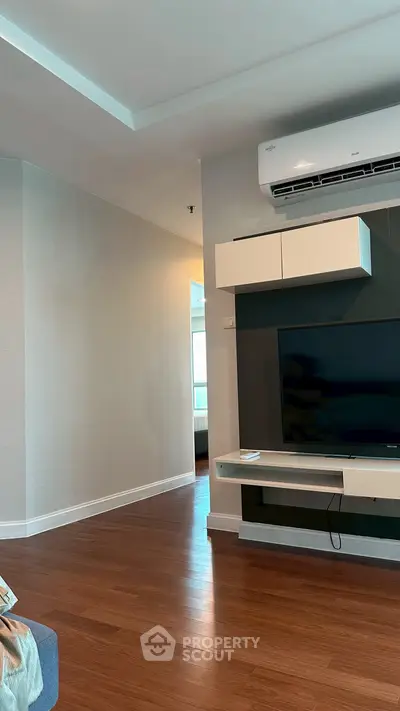 Modern living room with sleek TV unit and air conditioning