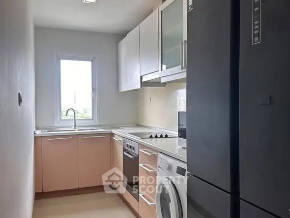 Modern kitchen with sleek appliances and ample storage space