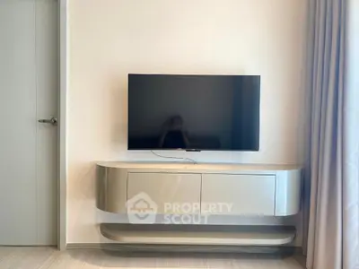 Modern living room with sleek TV stand and wall-mounted flat screen