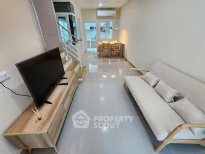 Modern living room with sleek furniture and open kitchen layout