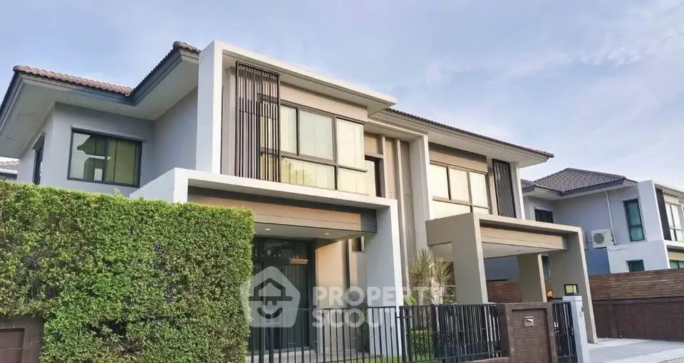 Modern two-story house with sleek design and lush greenery, perfect for contemporary living.