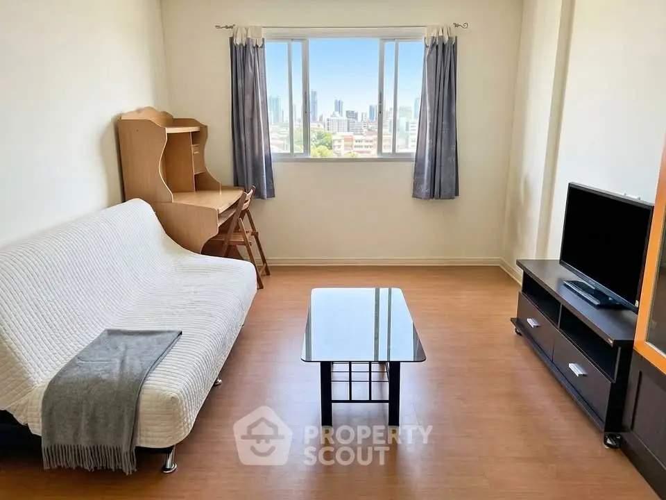 Bright living room with city view, featuring a cozy sofa, modern TV stand, and wooden desk.