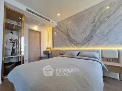 Luxurious bedroom with marble accent wall and modern decor