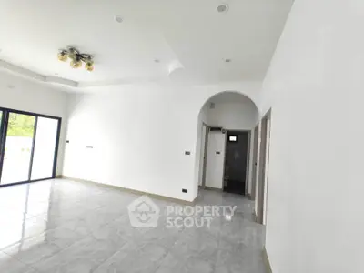 Spacious modern living room with elegant lighting and large windows