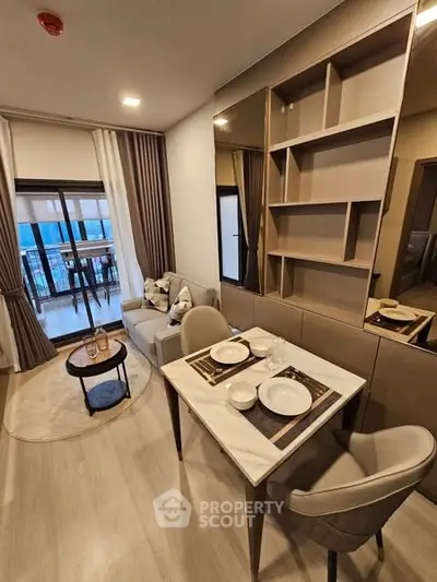 Modern living room with dining area and balcony view in stylish apartment