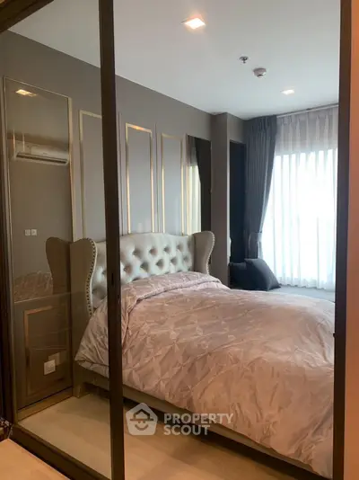 Luxurious bedroom with elegant decor and large window for natural light