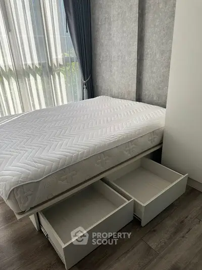 Modern bedroom with storage bed and large window for natural light