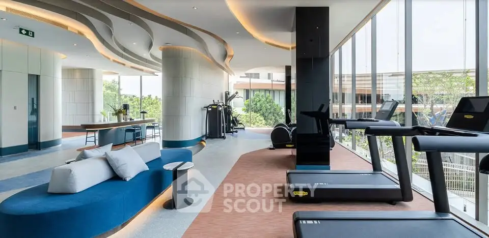Luxurious modern gym with panoramic windows and state-of-the-art equipment in upscale residential building.