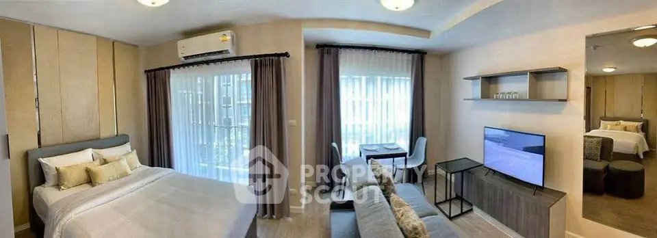 Modern studio apartment with cozy living area and stylish bedroom