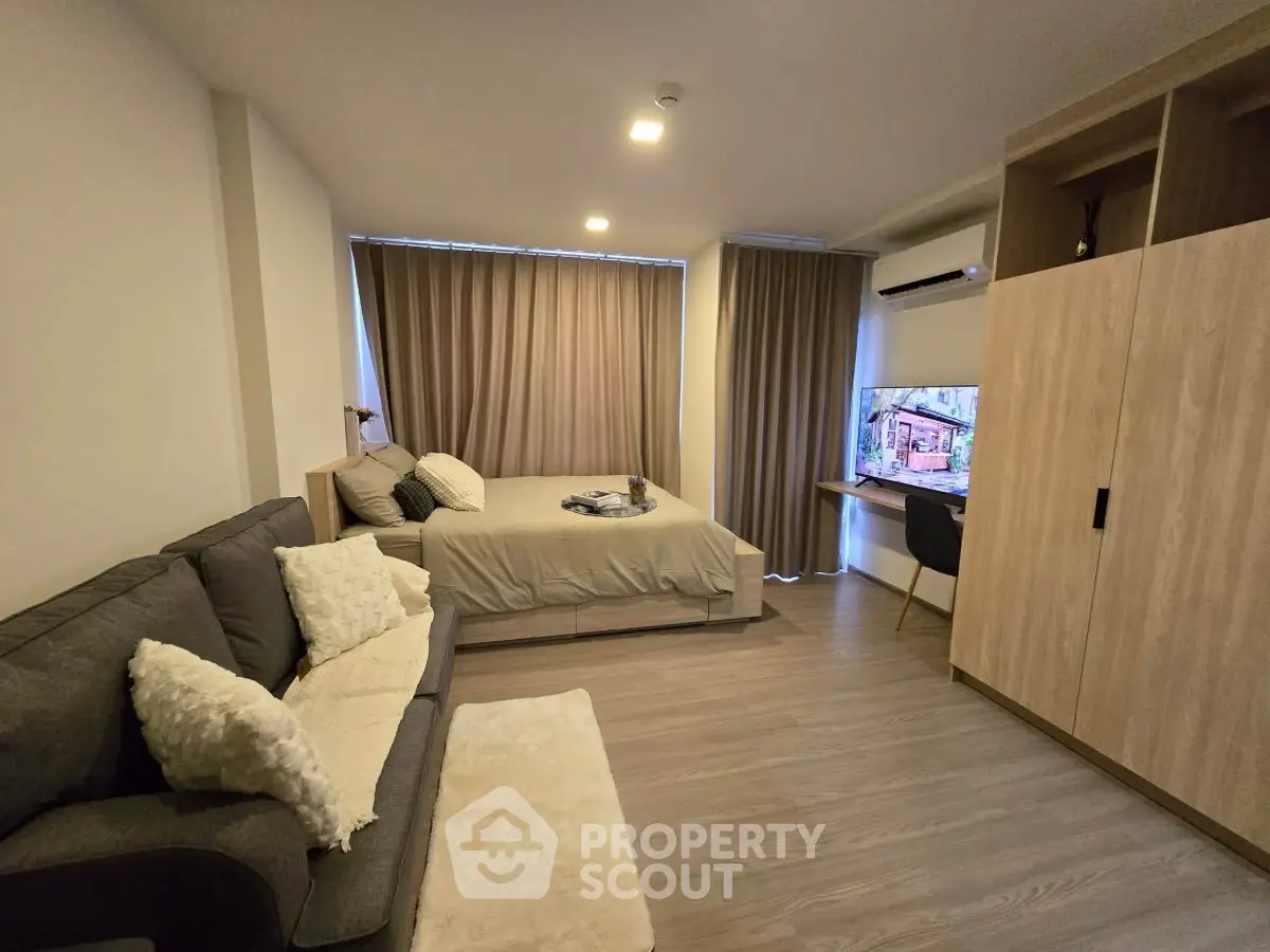 Modern studio apartment with cozy living area and stylish decor