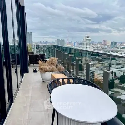Stunning high-rise balcony with panoramic city views and modern outdoor seating.