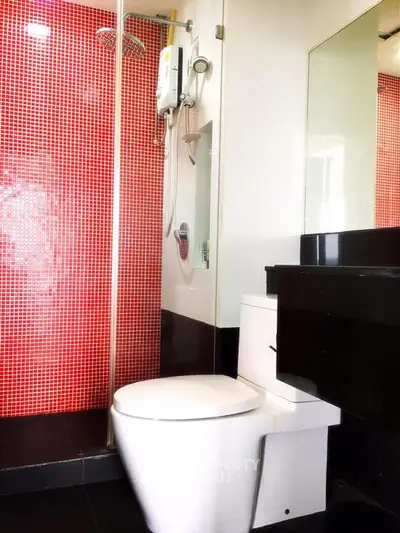 Modern bathroom with red mosaic tiles and sleek fixtures