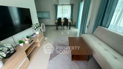 Spacious modern living room with stylish decor and large windows for natural light.