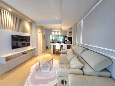 Modern living room with stylish decor and open kitchen layout
