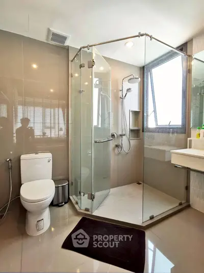 Modern bathroom with glass shower enclosure and sleek fixtures