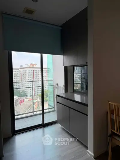 Modern apartment interior with balcony view and sleek cabinetry