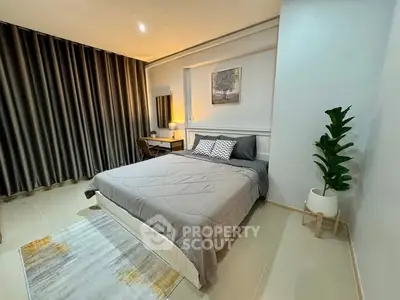 Modern bedroom with stylish decor and cozy ambiance, featuring a comfortable bed and elegant furnishings.