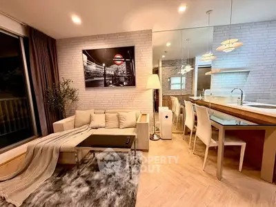 Modern living room with cozy seating and dining area, featuring stylish decor and warm lighting.