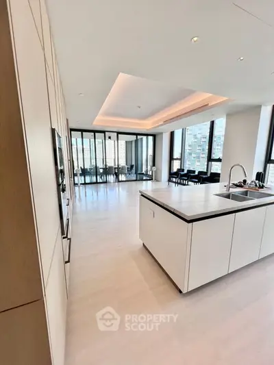 Luxurious open-plan kitchen with island and stunning city view, perfect for modern living.