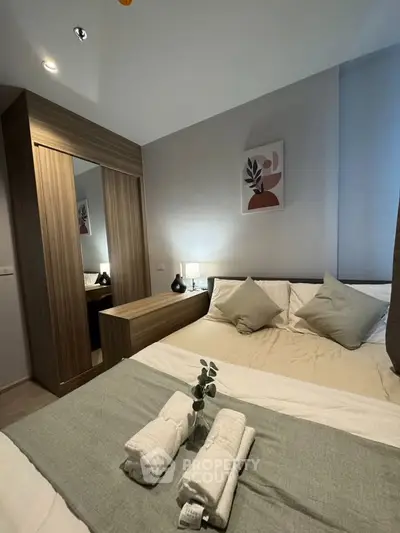 Cozy bedroom with modern decor and stylish wooden wardrobe
