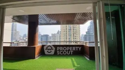 Spacious balcony with artificial grass and stunning city skyline view
