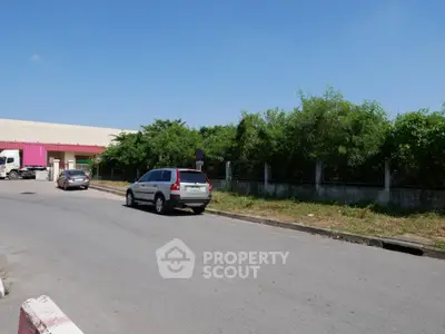 Spacious industrial area with ample parking and greenery, ideal for commercial development.