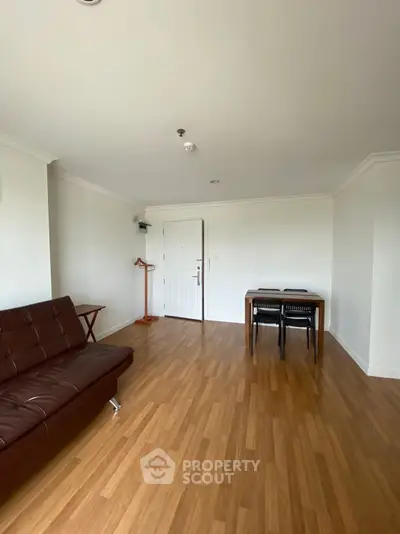 Spacious living room with wooden flooring and modern furniture