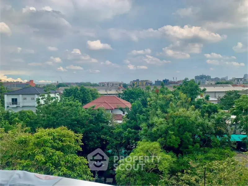 Stunning cityscape view with lush greenery and skyline in the background.