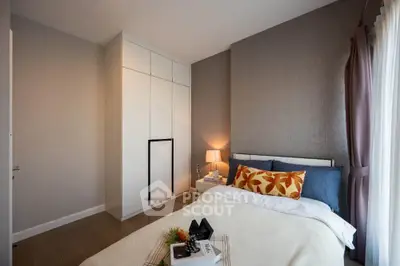 Cozy bedroom with modern decor and ample natural light