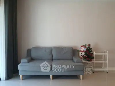 Cozy living room with modern gray sofa and festive decor, perfect for relaxation and holiday cheer.