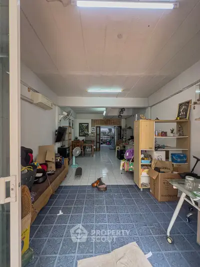 Spacious living area with tiled flooring and eclectic decor, ideal for creative customization.