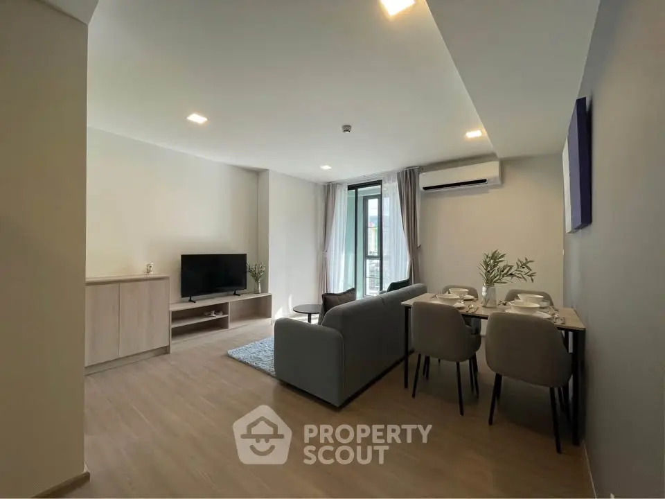 Modern living room with stylish furniture and natural light, perfect for relaxation and entertainment.