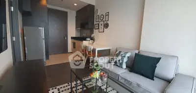 Modern living room with stylish decor and open kitchen layout in a cozy apartment.