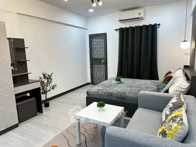 Modern studio apartment with cozy living area and stylish decor