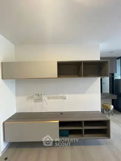 Modern minimalist study room with sleek built-in shelves and desk, perfect for productivity.