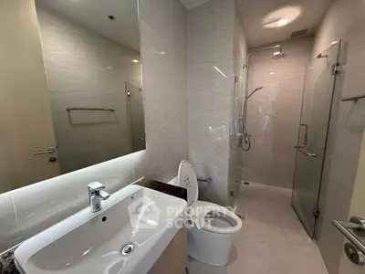 Modern bathroom with sleek fixtures and glass shower enclosure