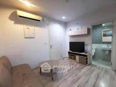 Modern living room with air conditioning and stylish decor adjacent to a bathroom.