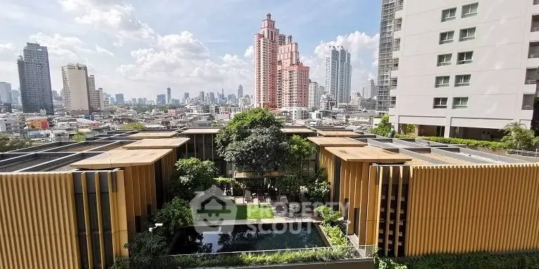 Stunning cityscape view from a modern building with lush garden and pool, perfect for urban living.