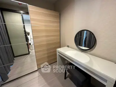 Modern bedroom with sleek vanity and mirrored closet doors