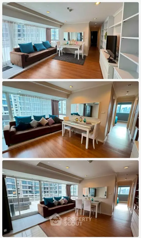 Spacious living room with large windows and modern decor in a high-rise apartment.