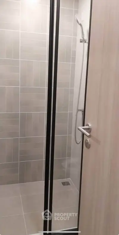 Modern bathroom with sleek shower design and neutral tiles