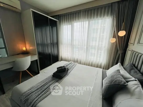 Modern bedroom with stylish decor and ample natural light