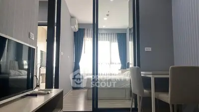 Modern apartment interior with glass partition, cozy bedroom, and stylish living area.